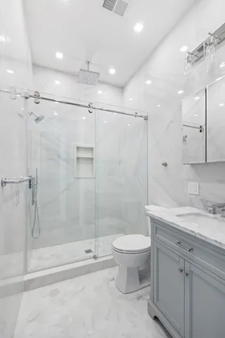 a bedroom with a bed and a mirror