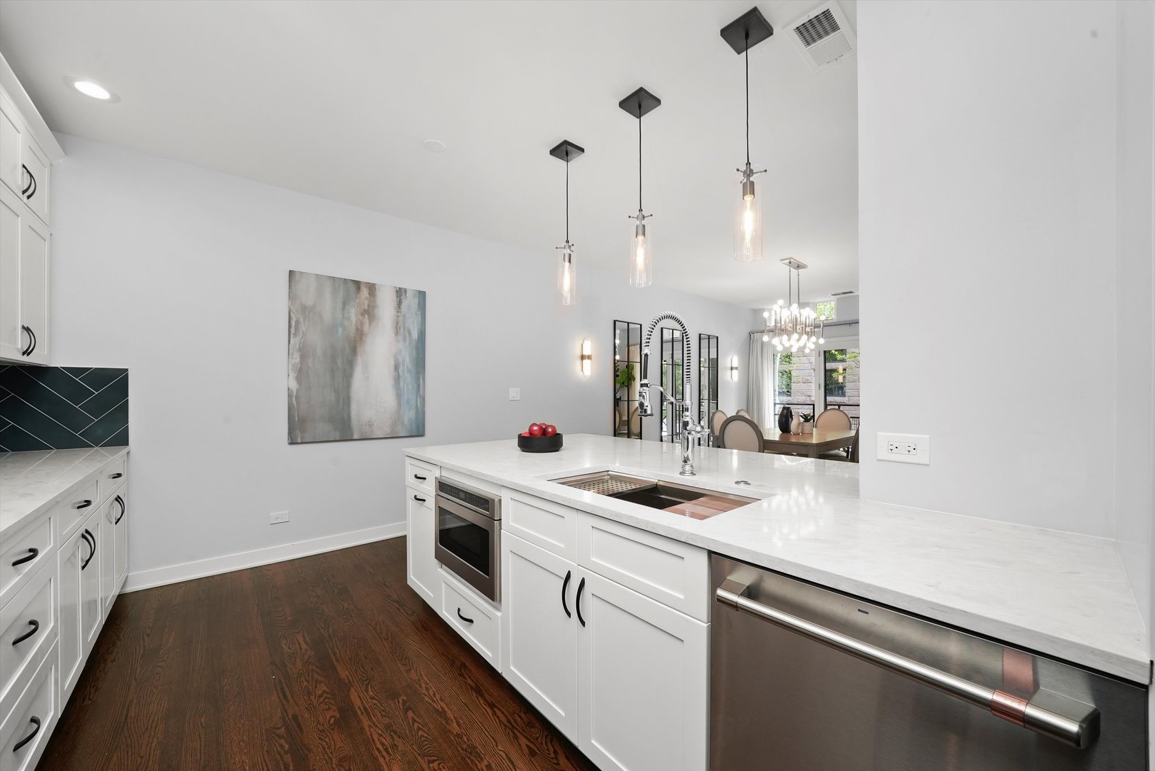 950 North Clark Street, Unit E Chicago, IL 60610 - Photo 19 of 52 a kitchen that has a sink a stove and a wooden floor