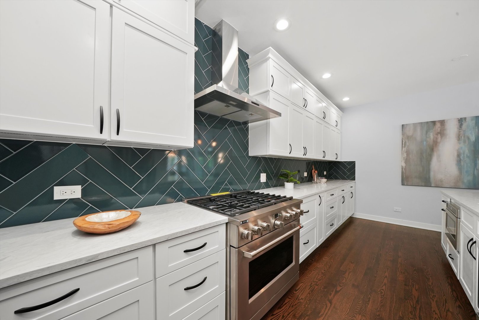 950 North Clark Street, Unit E Chicago, IL 60610 - Photo 21 of 52 a kitchen with stainless steel appliances granite countertop a sink a stove and a wooden floors