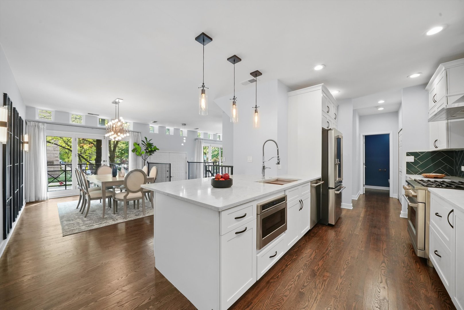 950 North Clark Street, Unit E Chicago, IL 60610 - Photo 23 of 52 a open kitchen with stainless steel appliances a stove top oven and a wooden floors