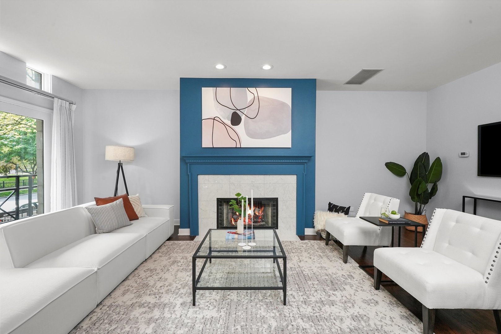 950 North Clark Street, Unit E Chicago, IL 60610 - Photo 3 of 52 a living room with furniture a fireplace and potted plants with wooden floor