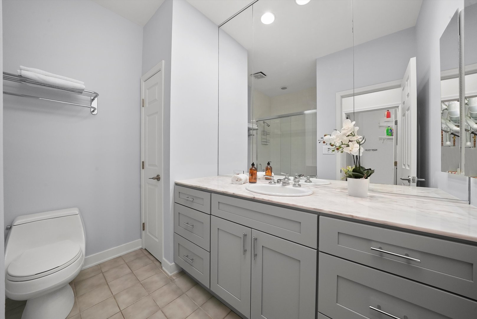 950 North Clark Street, Unit E Chicago, IL 60610 - Photo 35 of 52 a bathroom with a toilet sink and mirror