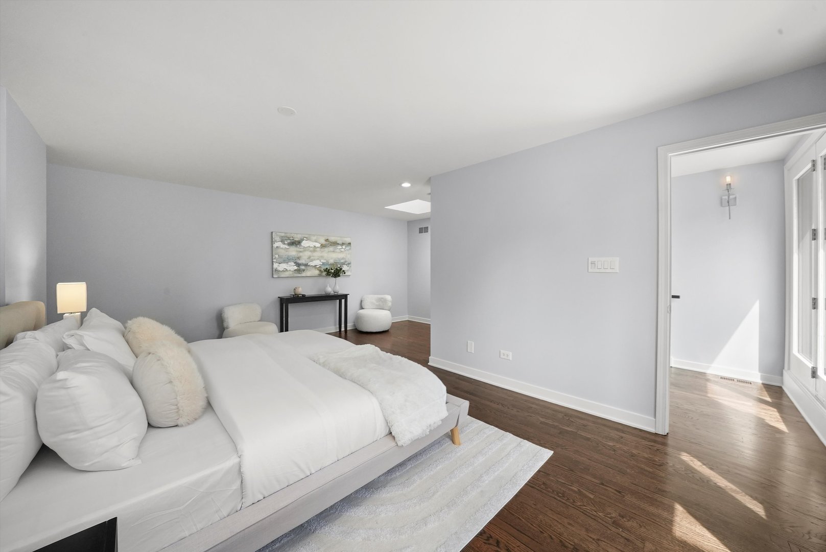 950 North Clark Street, Unit E Chicago, IL 60610 - Photo 37 of 52 a bedroom with a bed and wooden floor