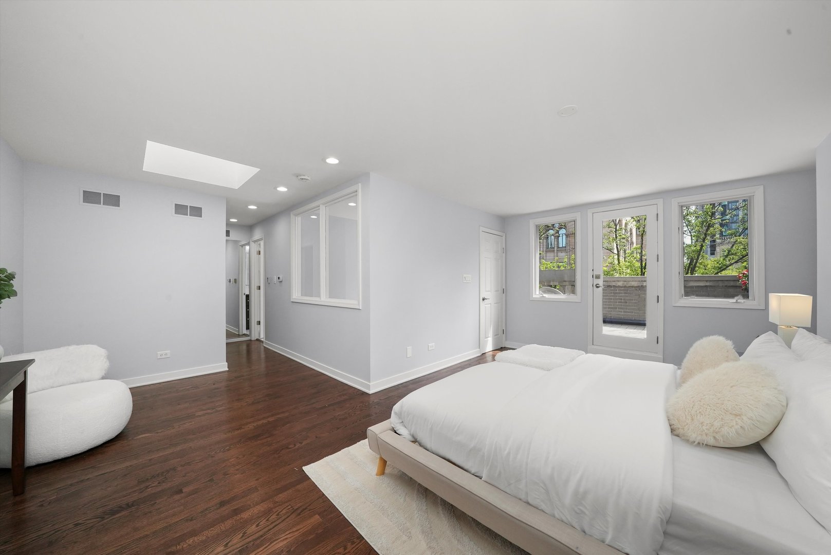 950 North Clark Street, Unit E Chicago, IL 60610 - Photo 40 of 52 a bedroom with a bed and wooden floor