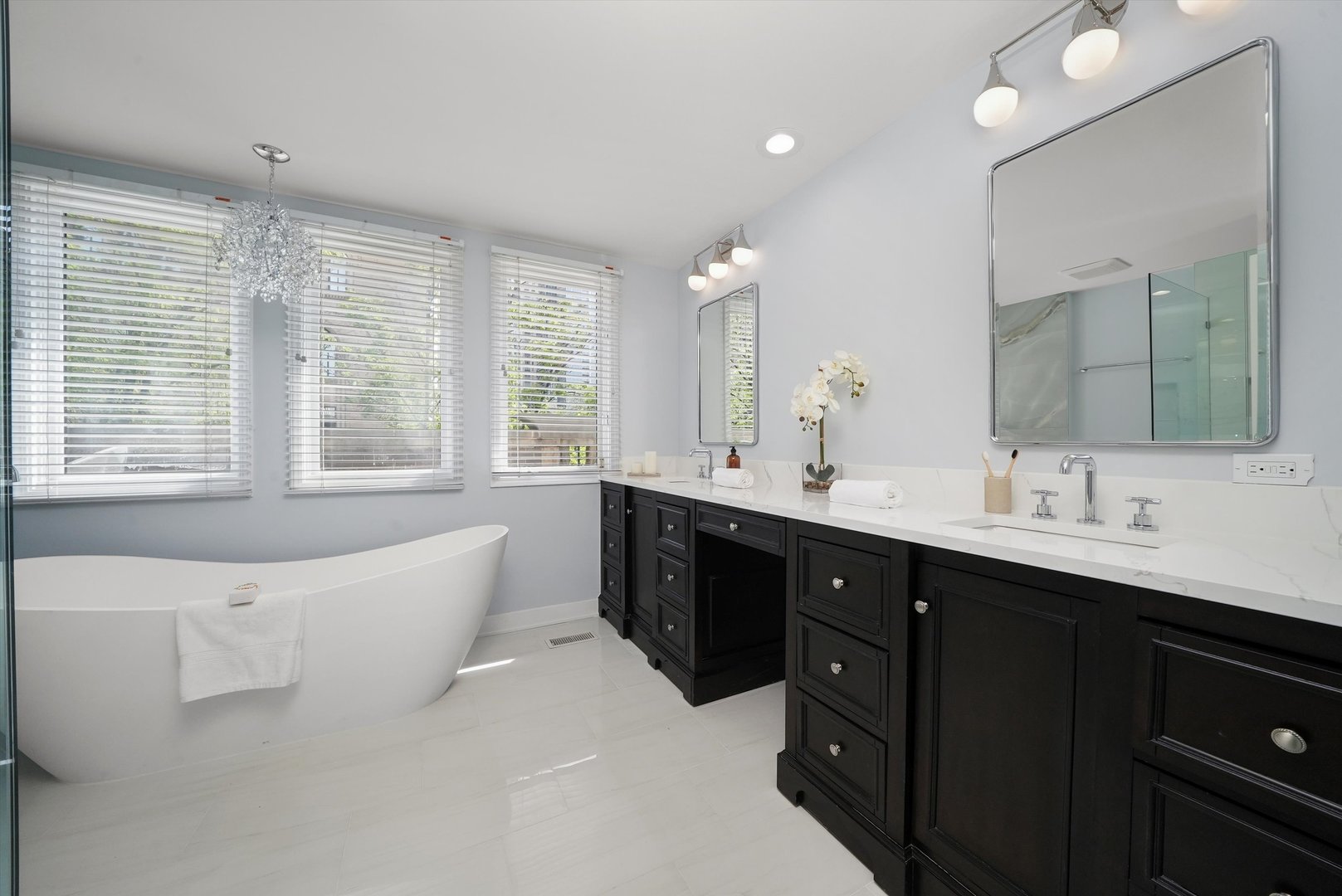 950 North Clark Street, Unit E Chicago, IL 60610 - Photo 44 of 52 a spacious bathroom with a double vanity sink large mirror and a bathtub