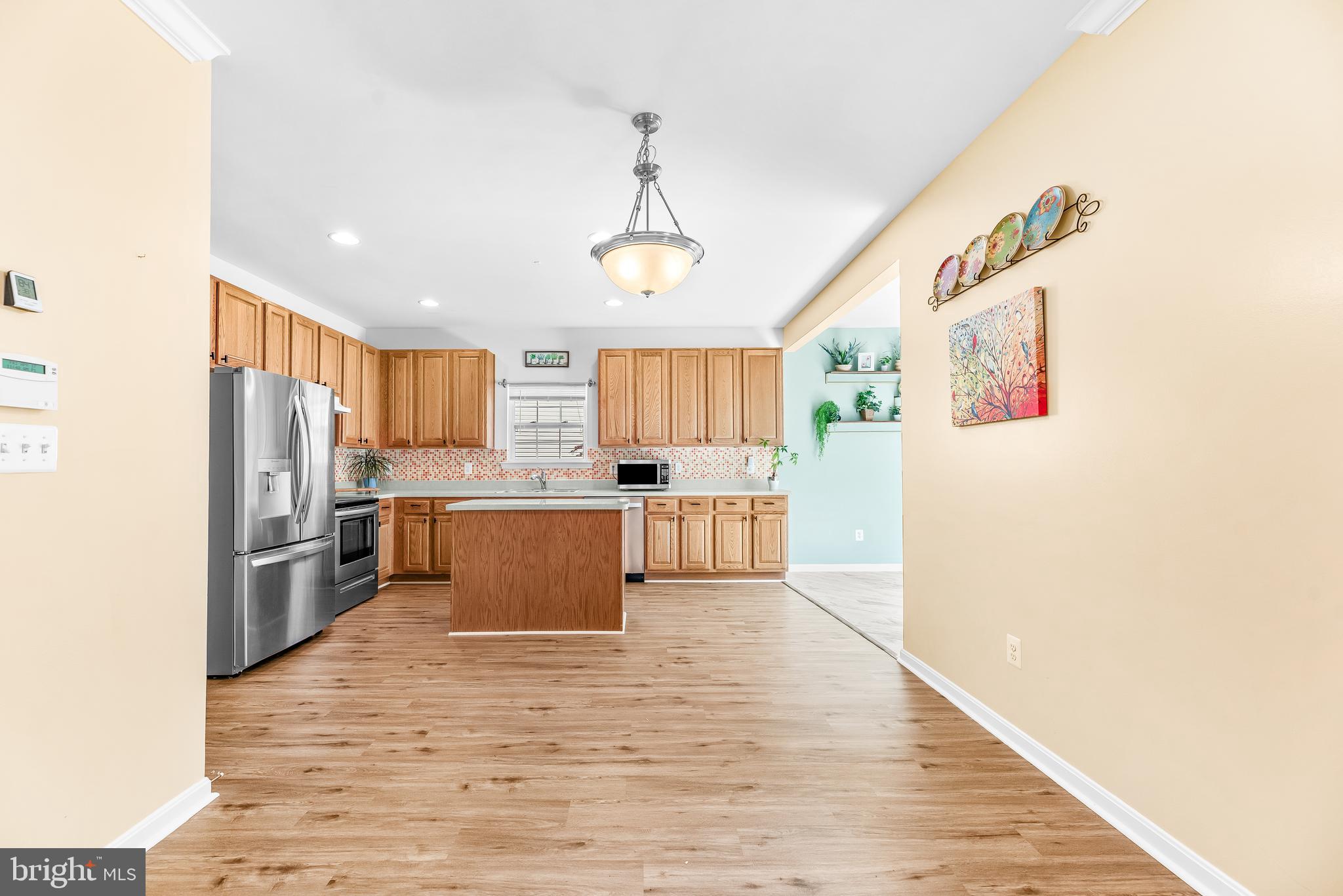 252 Rimfire Way Prince Frederick, MD 20678 - Photo 12 of 35 a large kitchen with cabinets wooden floor and stainless steel appliances