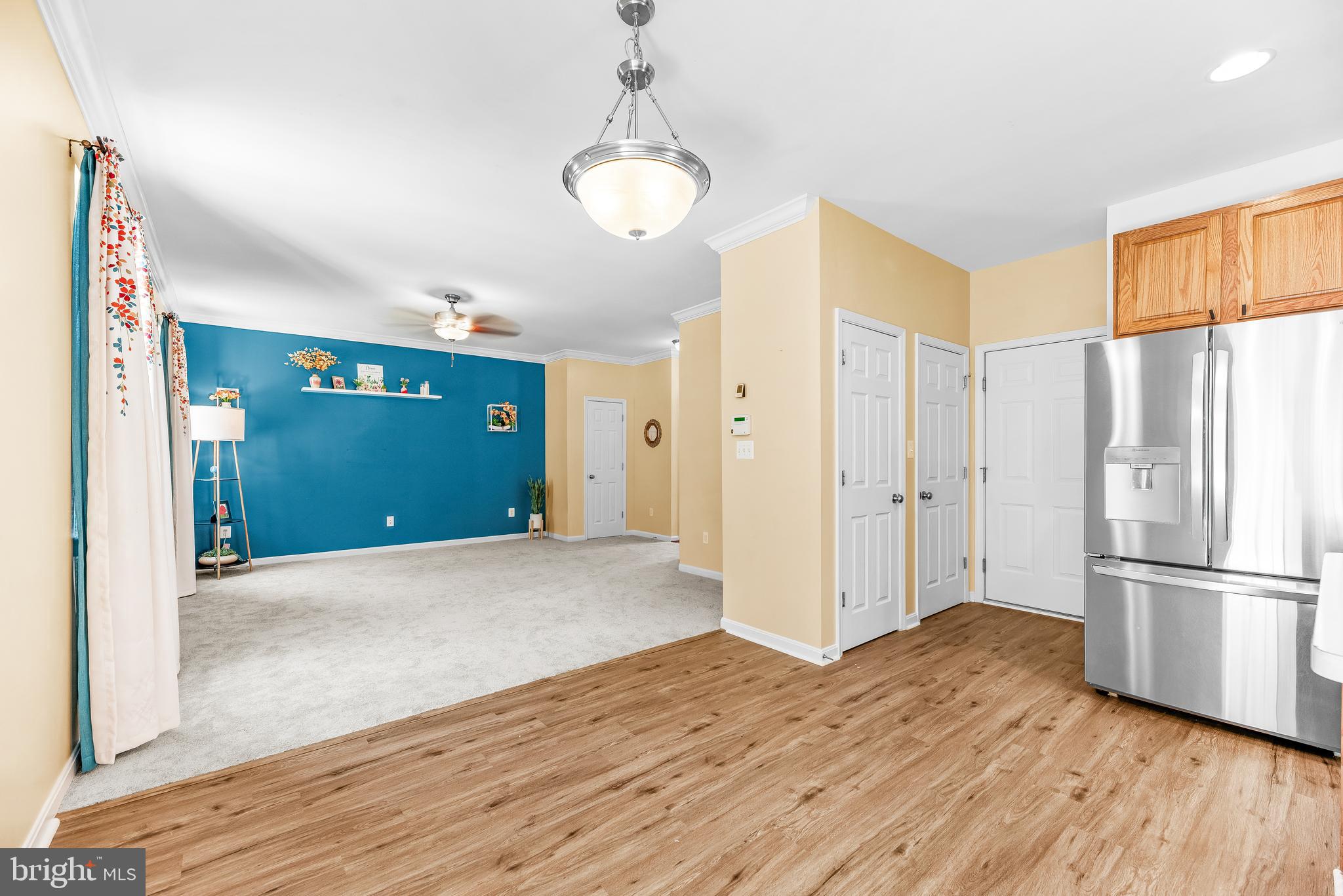 252 Rimfire Way Prince Frederick, MD 20678 - Photo 13 of 35 a view of a kitchen with wooden floor and a refrigerator