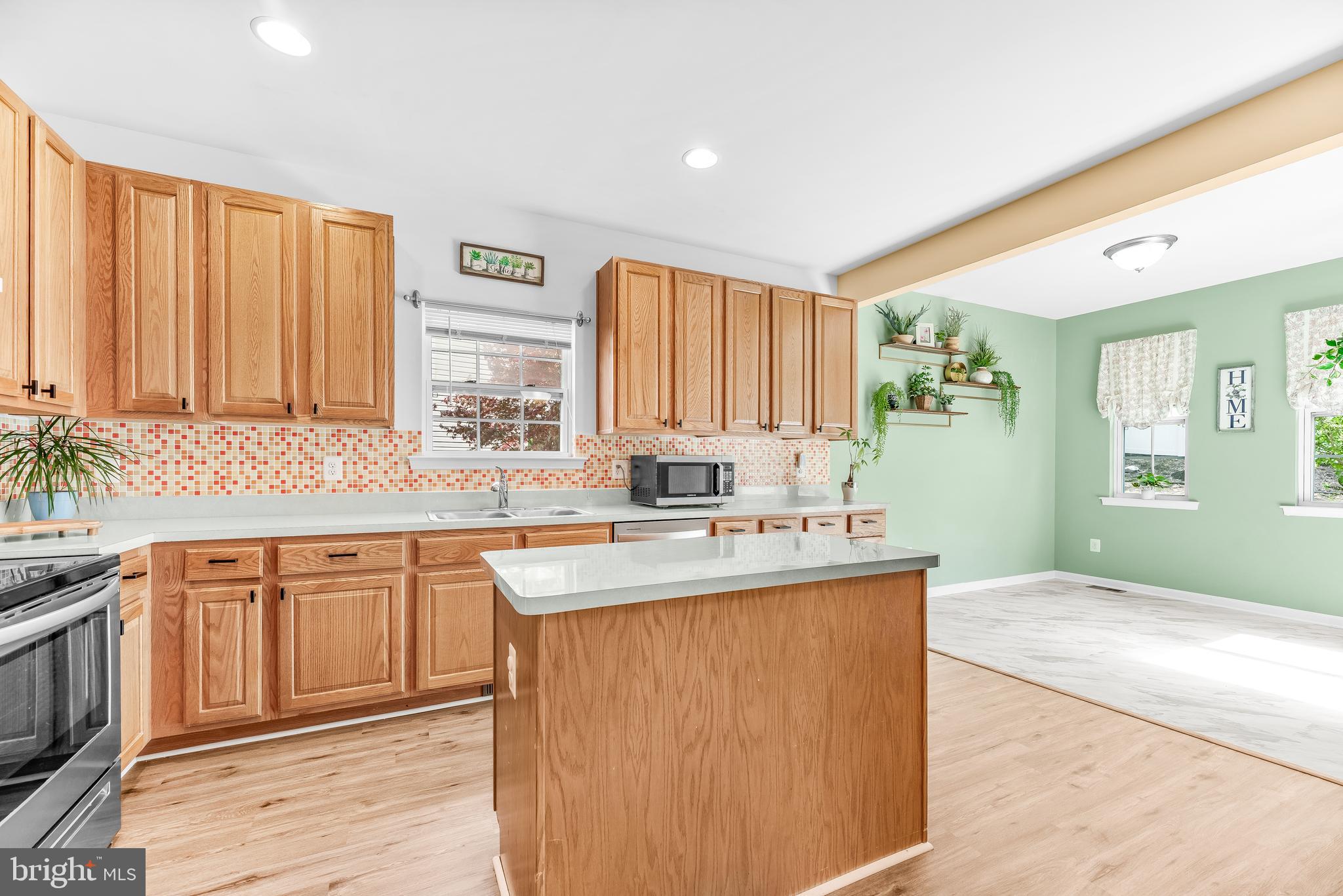 252 Rimfire Way Prince Frederick, MD 20678 - Photo 14 of 35 a kitchen with a sink stove and cabinets
