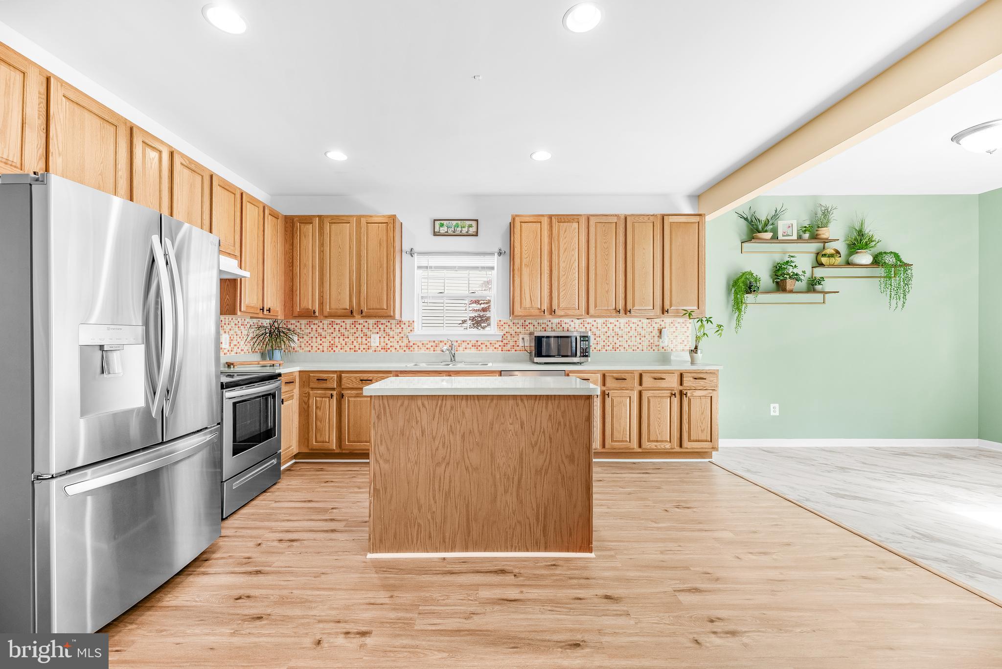 252 Rimfire Way Prince Frederick, MD 20678 - Photo 15 of 35 a kitchen with granite countertop a refrigerator stove top oven and sink