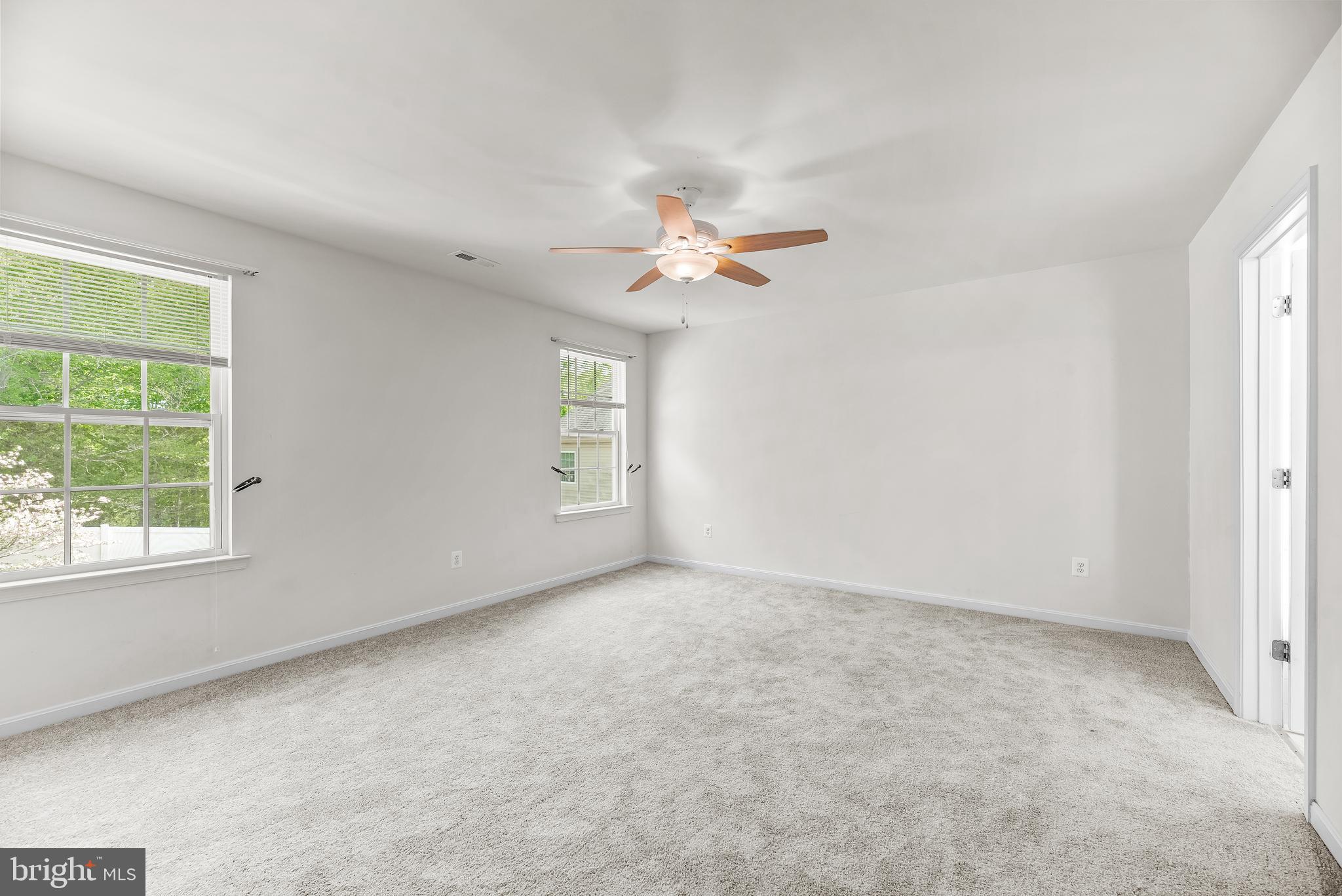 252 Rimfire Way Prince Frederick, MD 20678 - Photo 25 of 35 an empty room with windows and fan