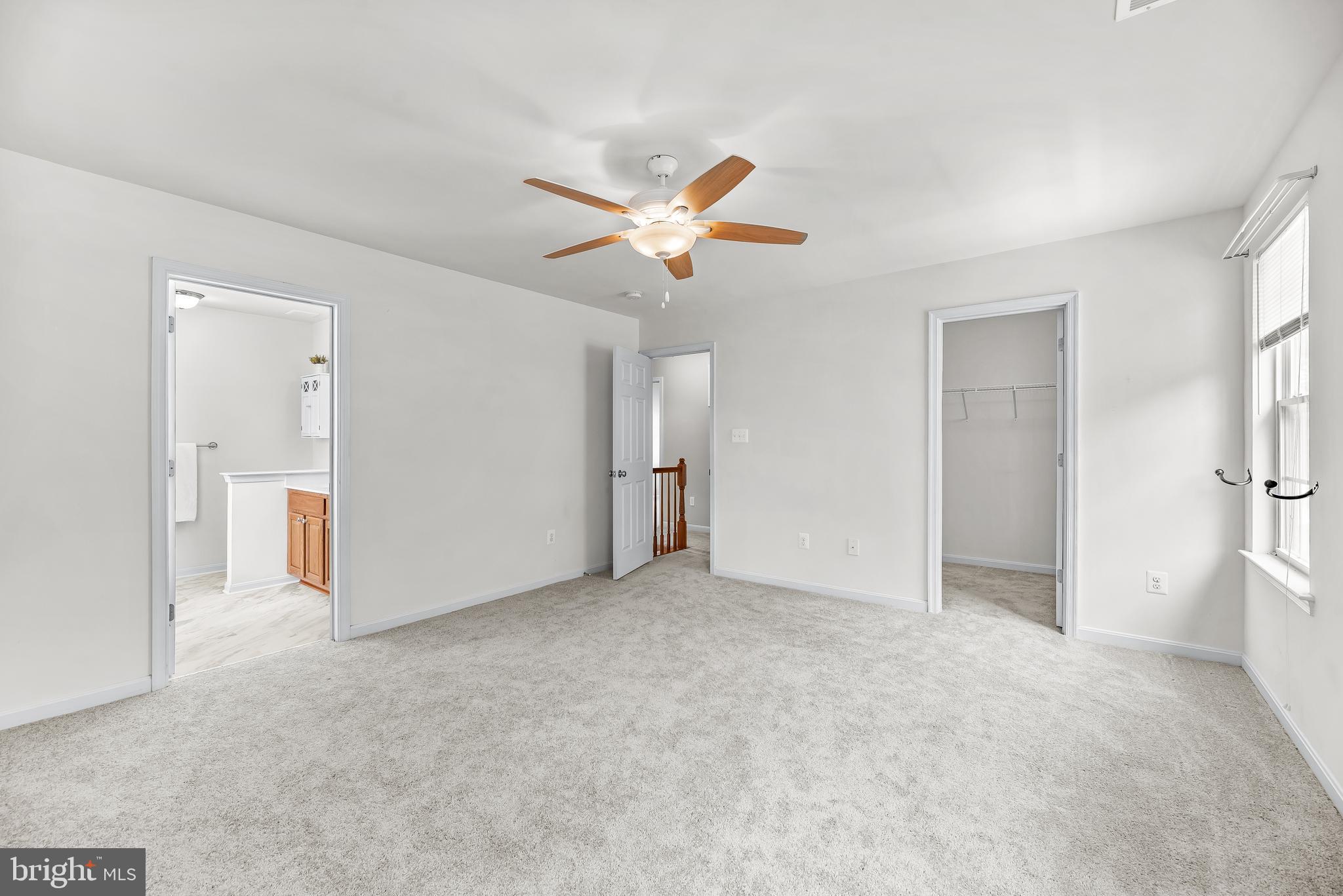 252 Rimfire Way Prince Frederick, MD 20678 - Photo 26 of 35 an empty room with closet and a ceiling fan