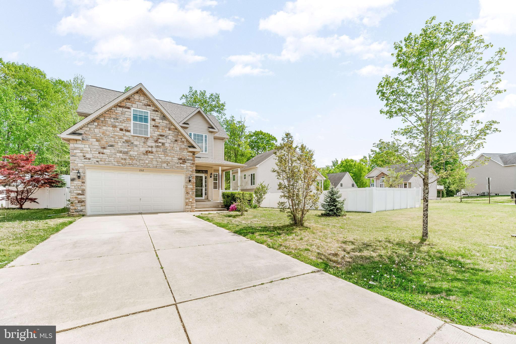 252 Rimfire Way Prince Frederick, MD 20678 - Photo 5 of 35 a front view of a house with a yard and garage