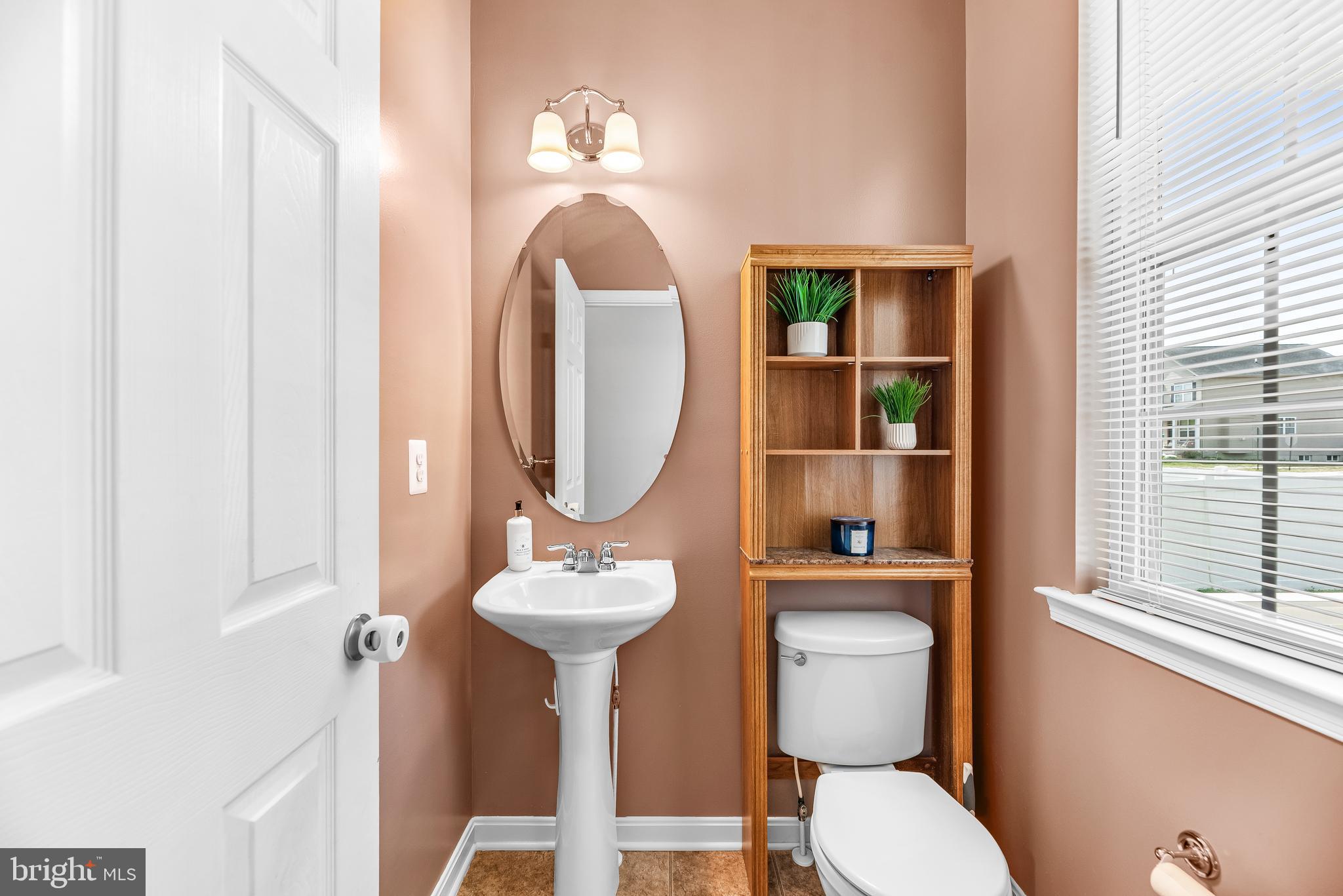 252 Rimfire Way Prince Frederick, MD 20678 - Photo 9 of 35 a bathroom with a toilet sink and mirror
