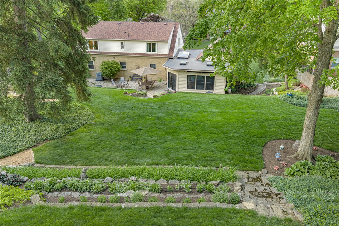 156 West Hadley Road Dayton, OH 45419 - Photo 68 of 71 This spacious backyard offers ample green space and a charming patio for outdoor enjoyment.
