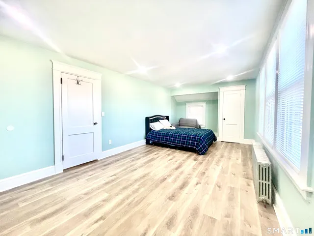 a spacious bedroom with a bed and a window