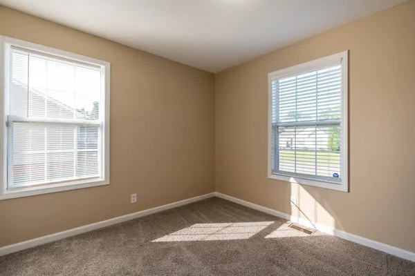an empty room with closet area