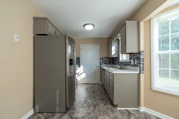 a kitchen with a refrigerator and a sink