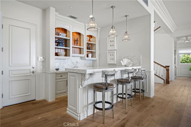 a view of a dining room with furniture and a chandelier