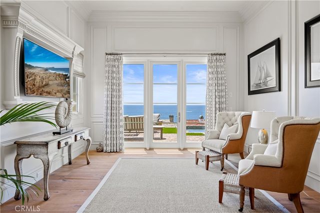 a living room with furniture and floor to ceiling windows
