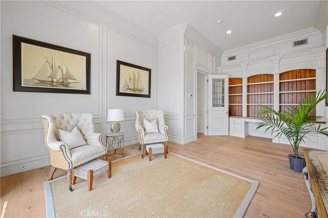 a living room with furniture potted plant and a table