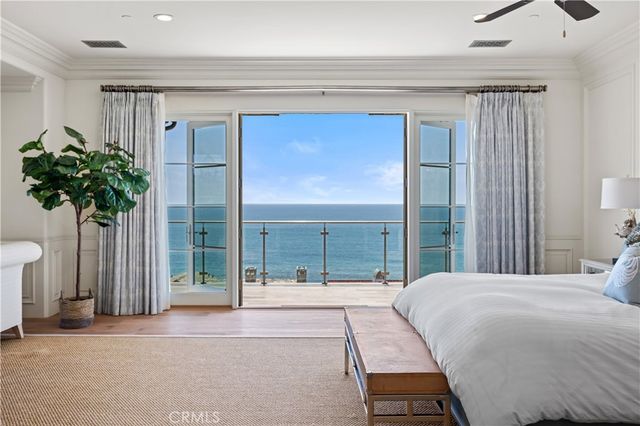 a bedroom with a balcony a bed and a potted plant
