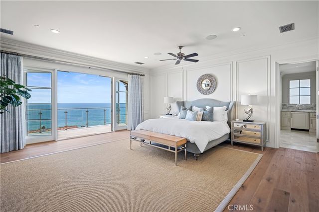 a spacious bedroom with a bed and a large window