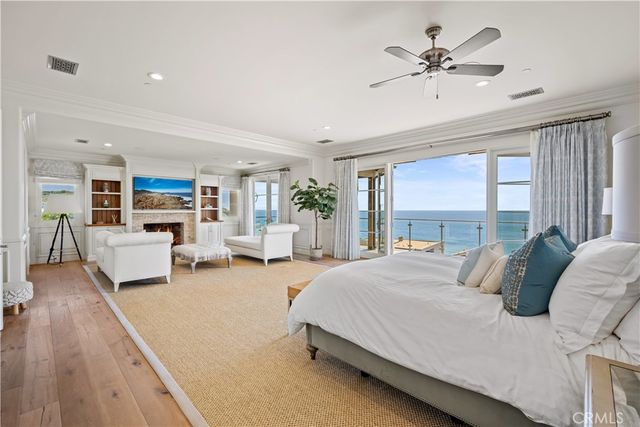 a bedroom with a large bed and a chandelier