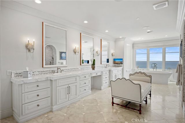 a large white kitchen with a lot of white furniture