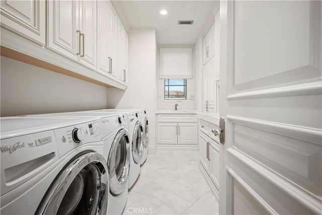 a view of washer and dryer with kitchen in the background