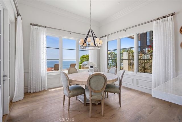 a dining room with furniture a chandelier and wooden floor