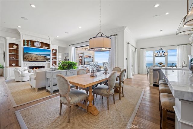 a dining room with stainless steel appliances kitchen island granite countertop a dining table chairs and view kitchen