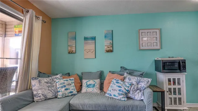 a living room with furniture and a floor to ceiling window