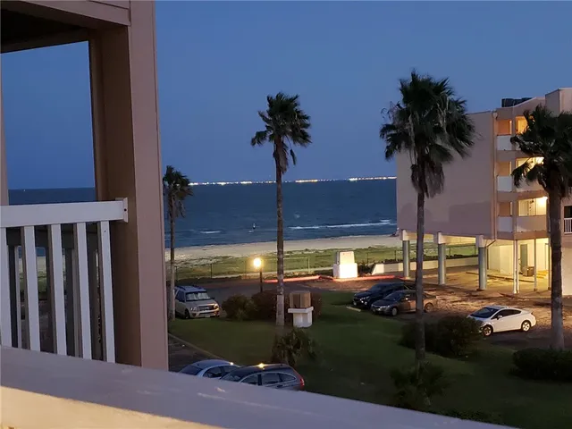 a view of a swimming pool with a yard and a fire pit
