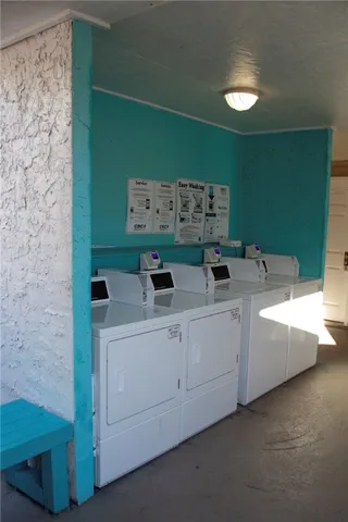a view of a park with a slide on the table and chairs