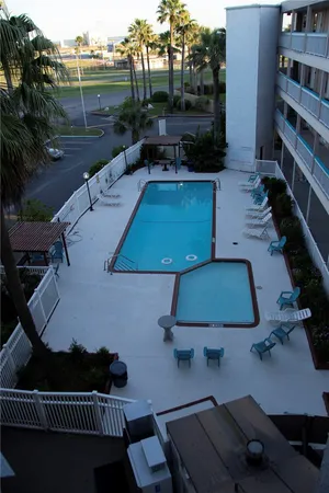 a view of a park with a slide on the table and chairs