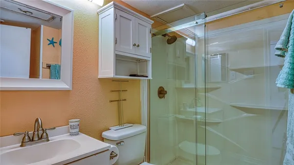 a bathroom with a sink toilet and shower