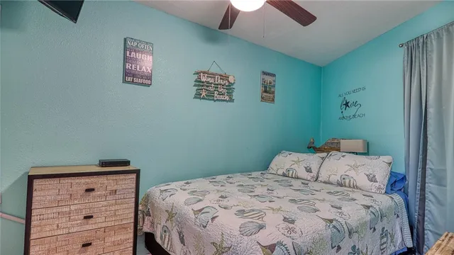a view of water with boats and trees in the background