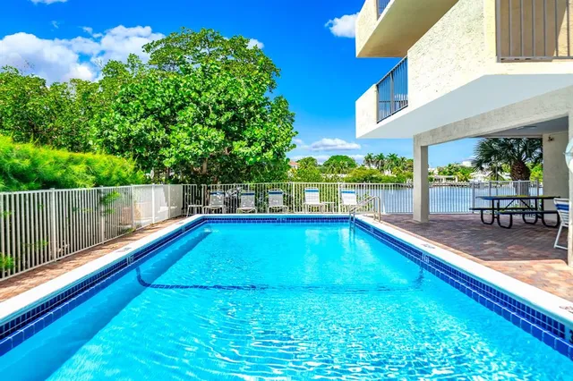 a view of swimming pool with chairs