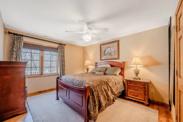 a bedroom with a bed and a window with the outer view