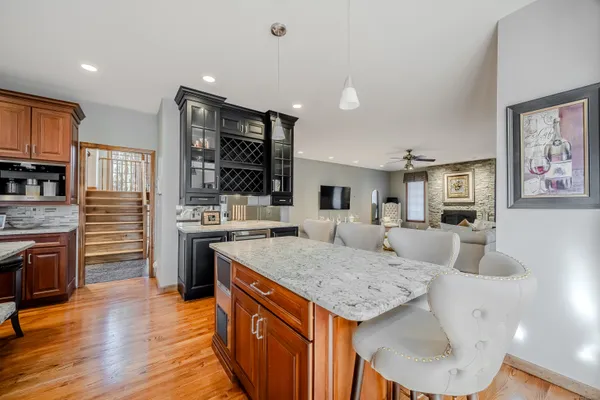 a large kitchen with granite countertop a sink and cabinets