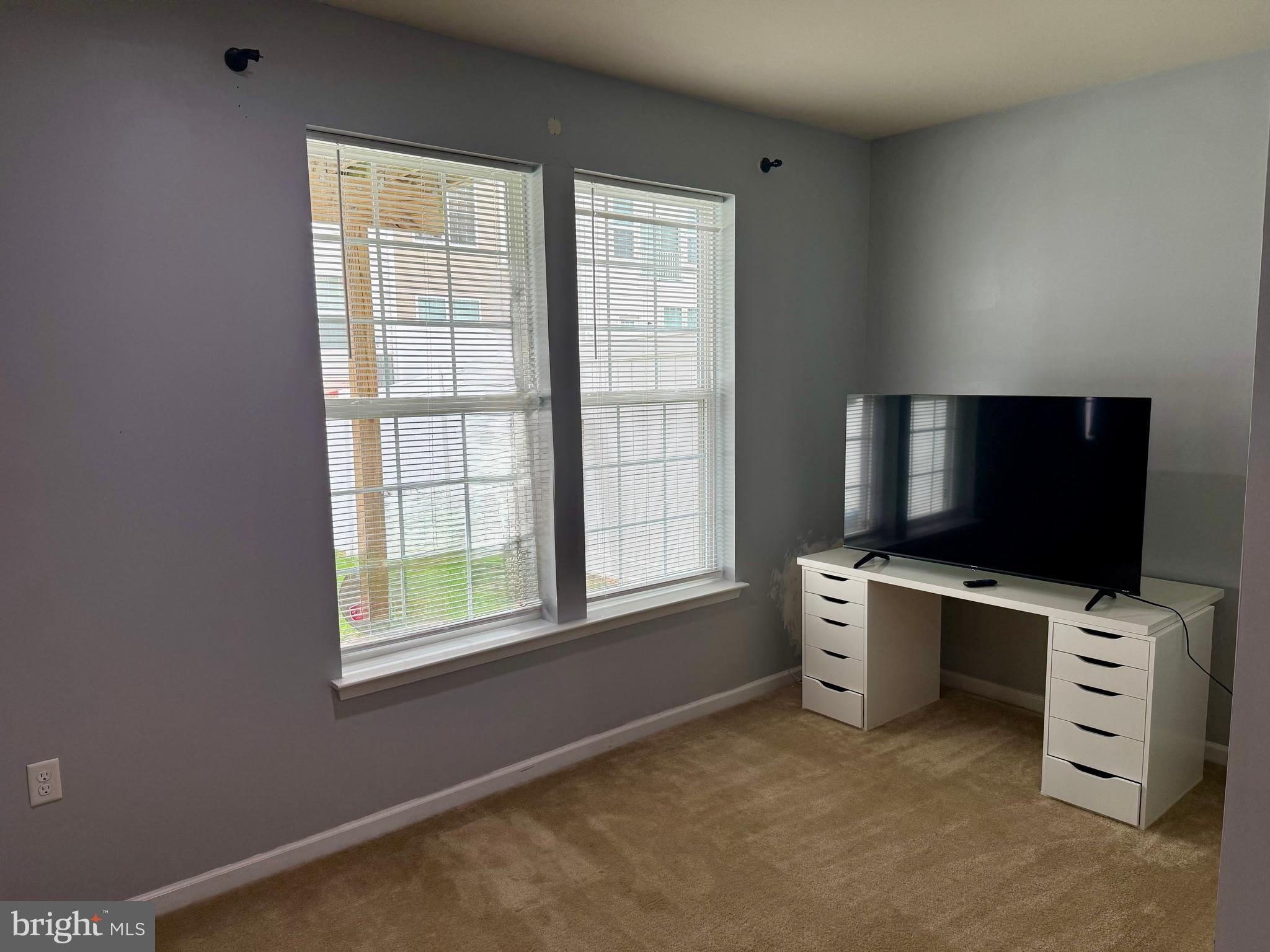 236 Schramm Loop Stephens City, VA 22655 - Photo 6 of 26 an empty room with a flat screen tv and windows