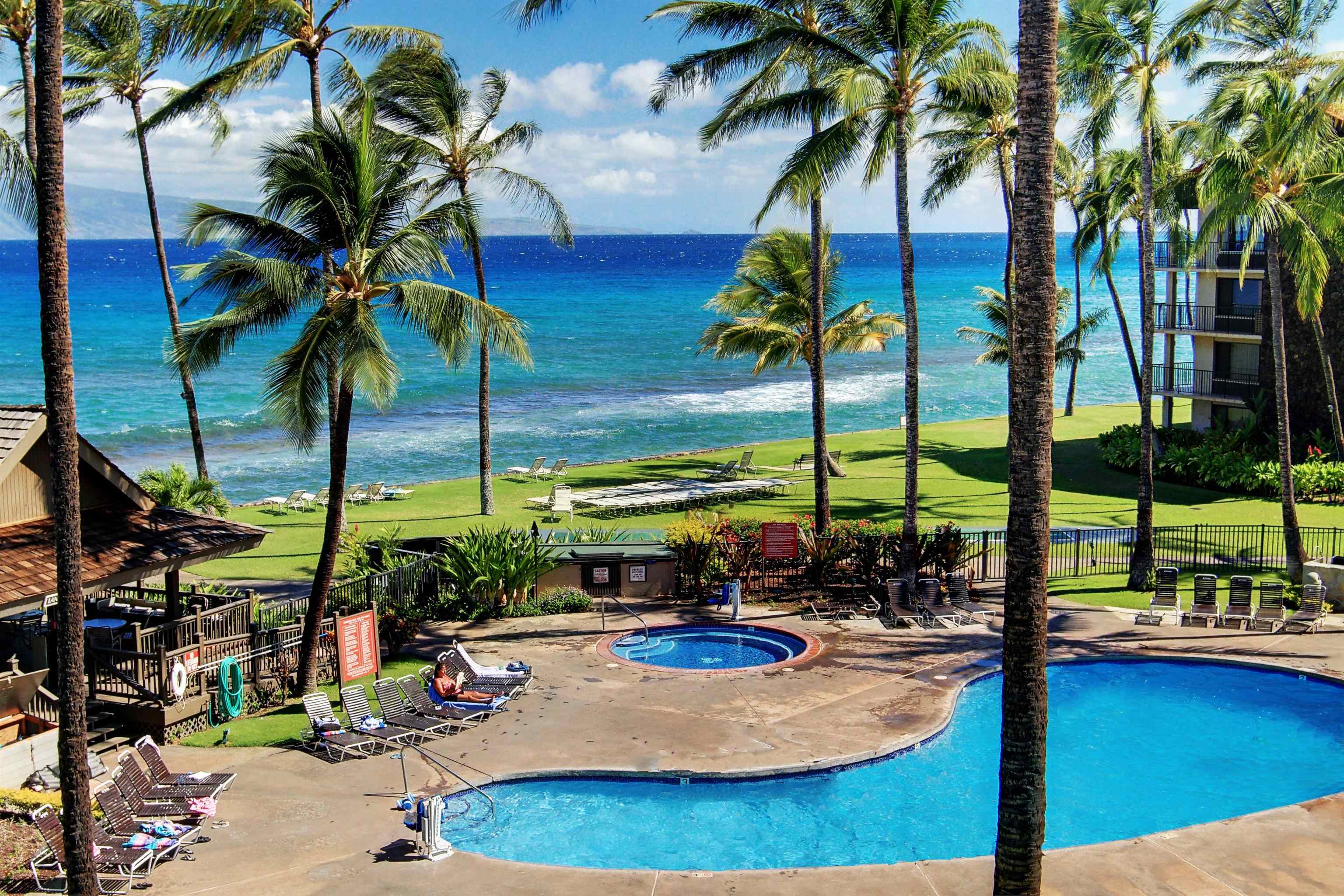 3543 Lower Honoapiilani Road, Unit K403 Lahaina, HI 96761 - Photo 11 of 29 a view of a swimming pool with a table and chairs