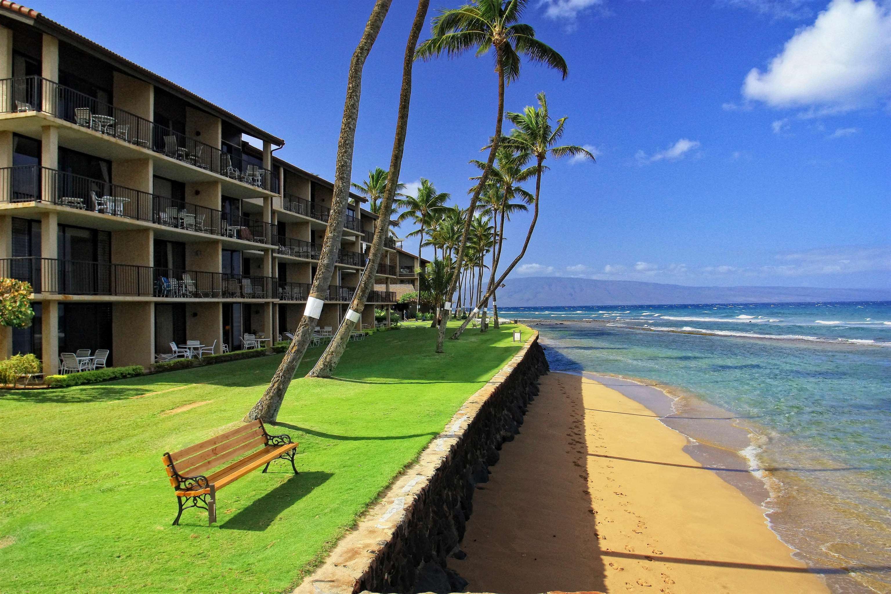 3543 Lower Honoapiilani Road, Unit K403 Lahaina, HI 96761 - Photo 23 of 29 a view of a swimming pool with an outdoor seating and a yard