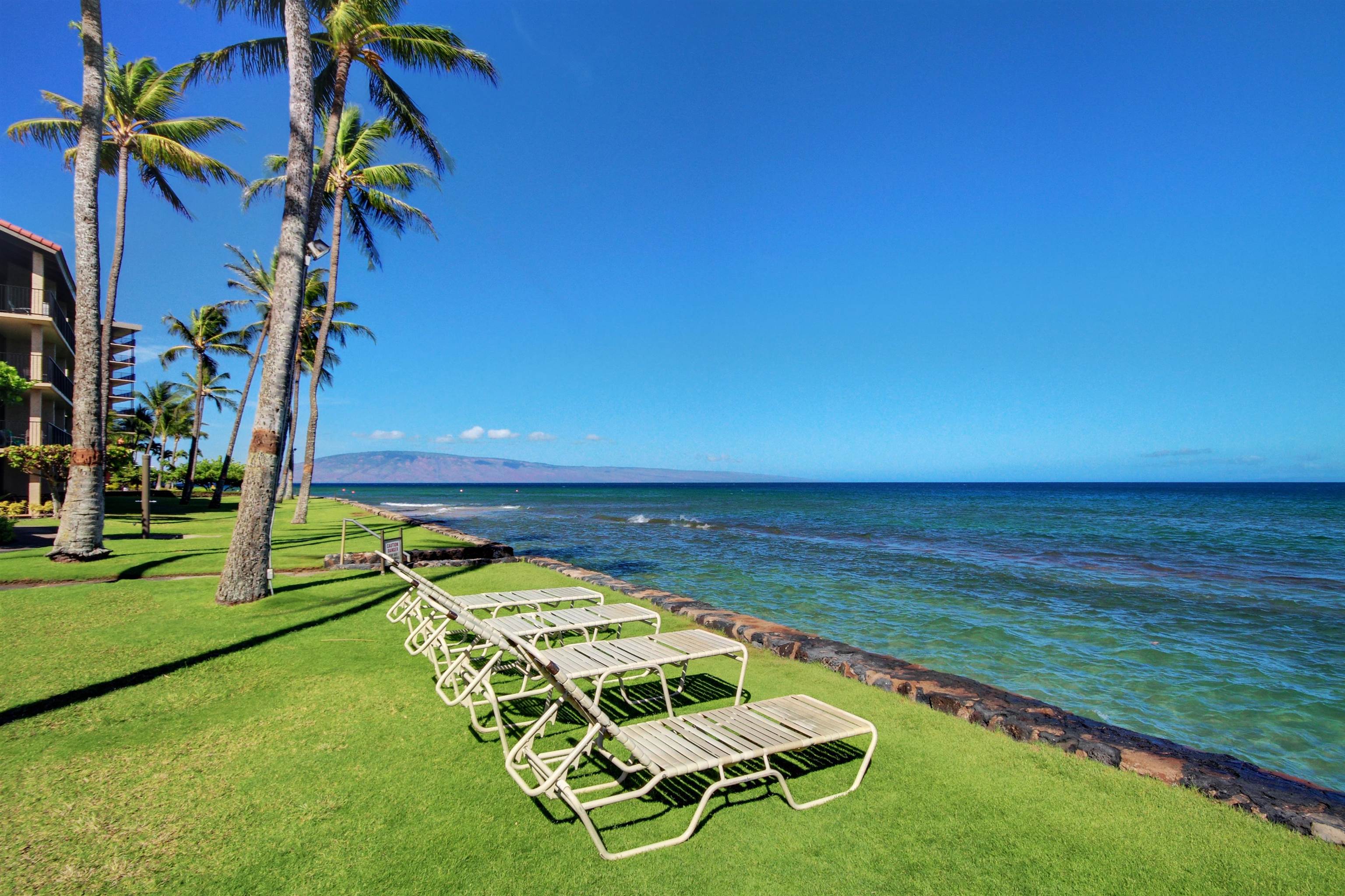3543 Lower Honoapiilani Road, Unit K403 Lahaina, HI 96761 - Photo 26 of 29 a view of a swimming pool with an outdoor space and seating area