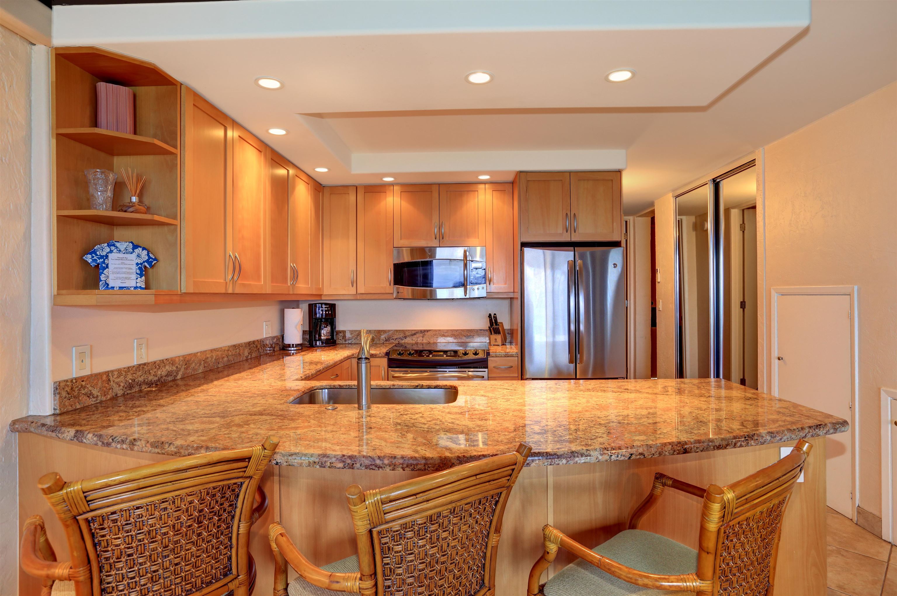 3543 Lower Honoapiilani Road, Unit K403 Lahaina, HI 96761 - Photo 3 of 29 a kitchen with stainless steel appliances granite countertop a sink and a refrigerator