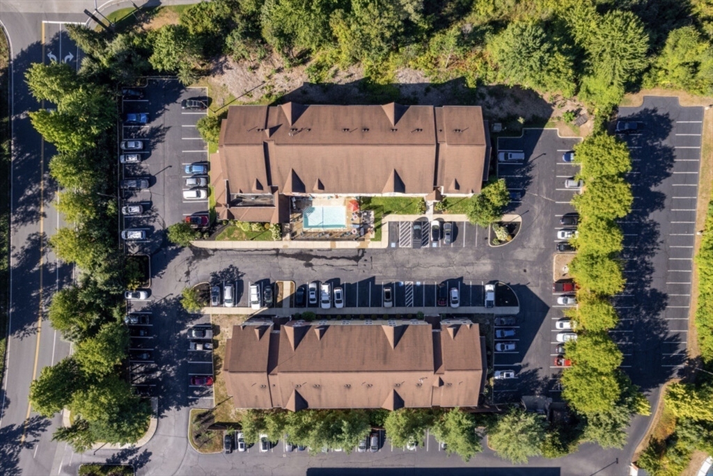 20 International Place, Unit 310 Tewksbury, MA 01876 - Photo 19 of 27 an aerial view of a house with a yard and large trees
