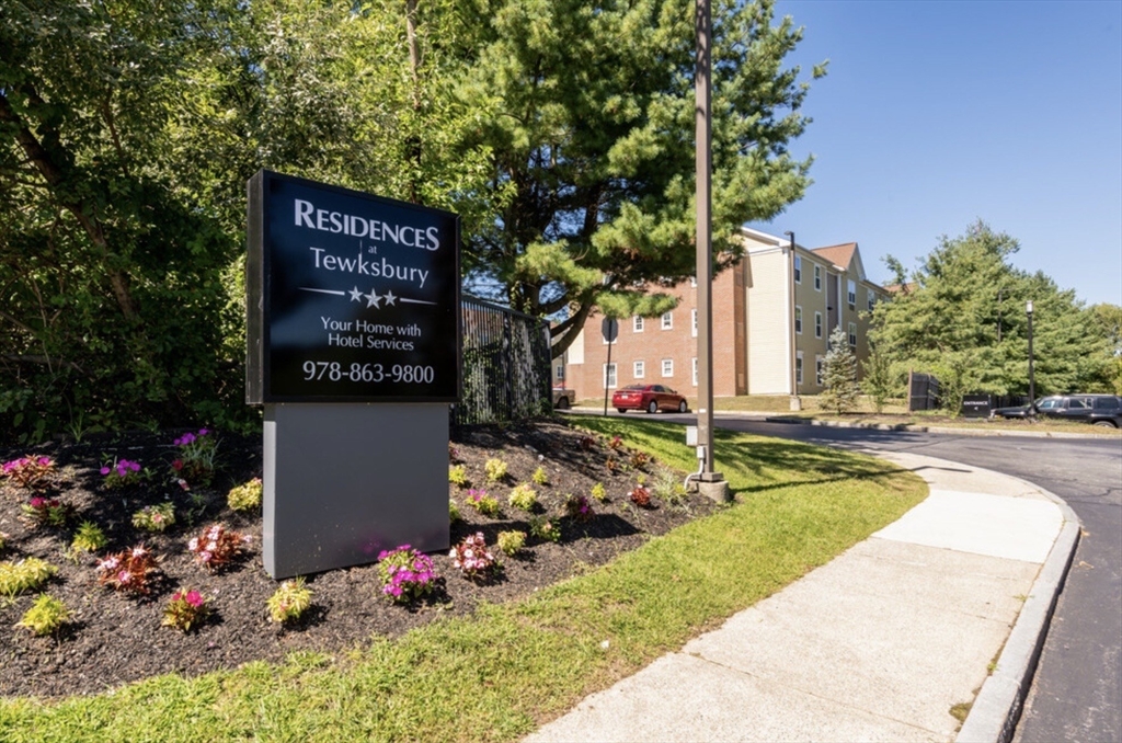 20 International Place, Unit 310 Tewksbury, MA 01876 - Photo 2 of 27 a view of swimming pool with a garden