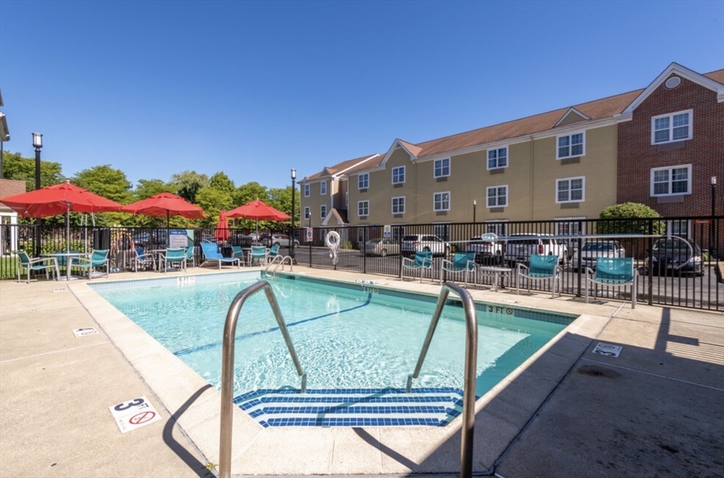 20 International Place, Unit 310 Tewksbury, MA 01876 - Photo 25 of 27 a view of swimming pool with outdoor seating