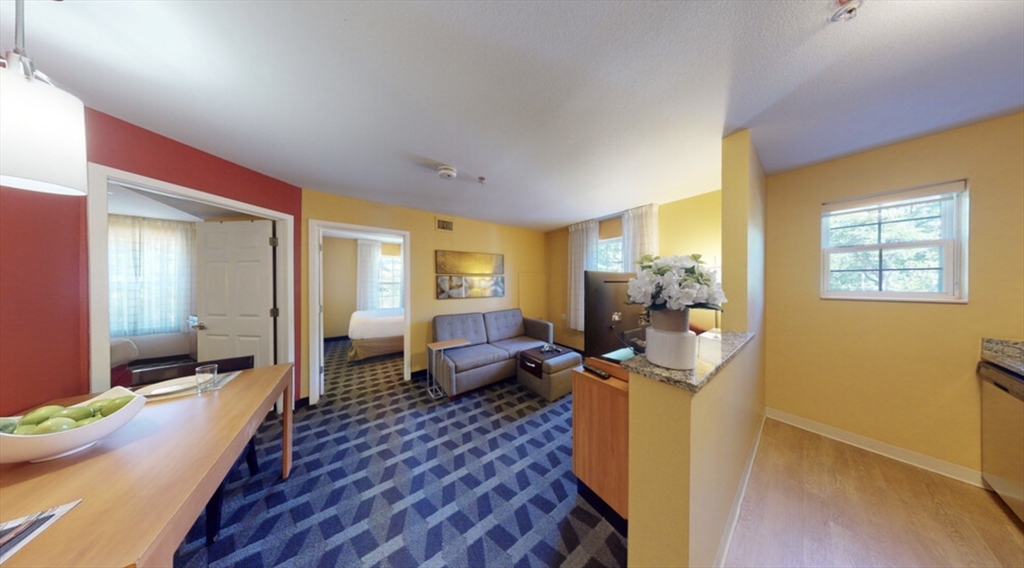 20 International Place, Unit 310 Tewksbury, MA 01876 - Photo 7 of 27 a living room with furniture and a table