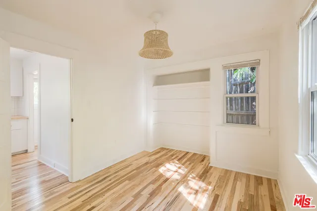 a view of a livingroom with wooden floor and window